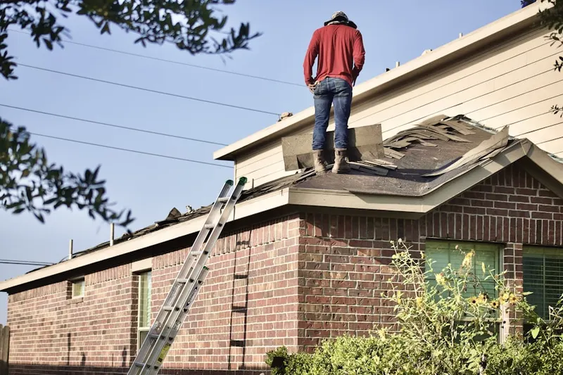Professional roofer working on a residential roof in Woodridge